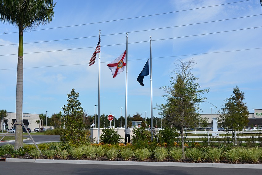 Veterans in VFW Post 12055 help raise the American and other flags during the Oct. 15 ceremony.
