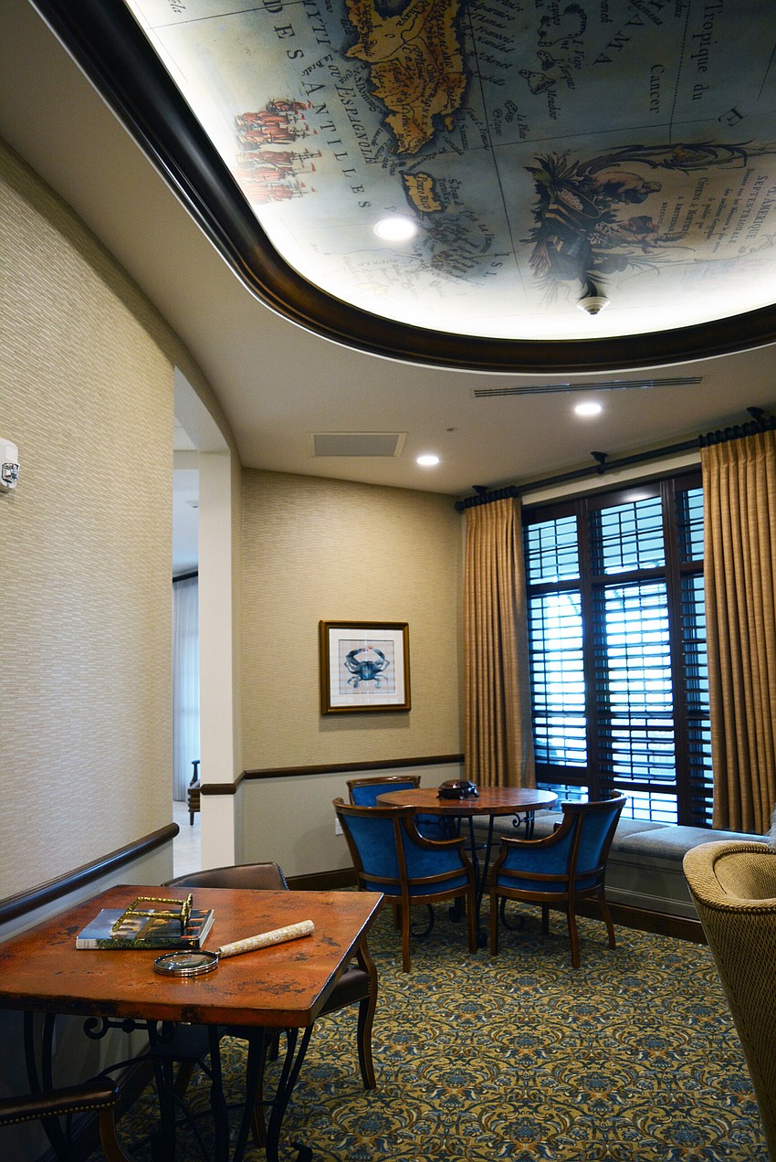 Grand Living at Lakewood Ranch is designed to feel like a luxurious resort. This room is a library area with books and tables.