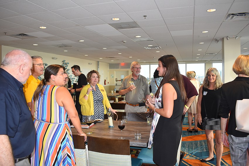 Members mingled in the top floor of the Holiday Inn Lido Beach.