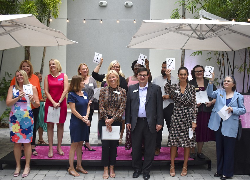 The grant finalists hold up their number cards that announce the order they will present their projects in.