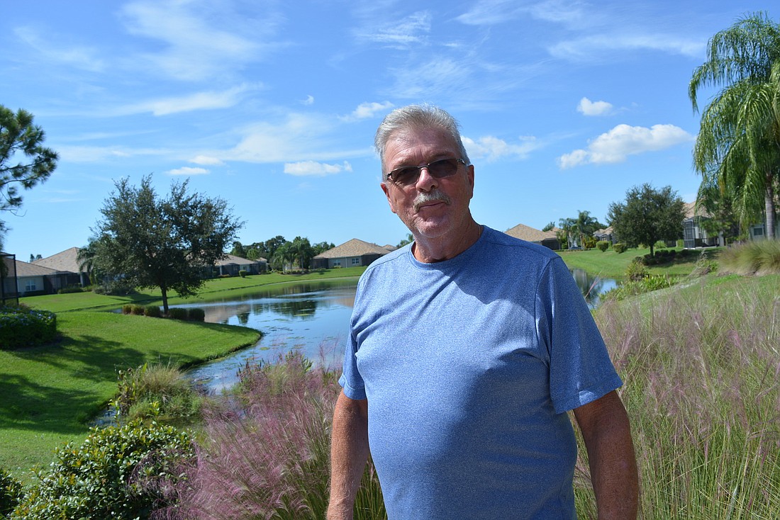 Fairfield resident Brian Dunne stand at the center of his community, where the pool and mailboxes are located. Behind him is an unobstructed skyline. He and others worry about the visual impact a five-story building could have.