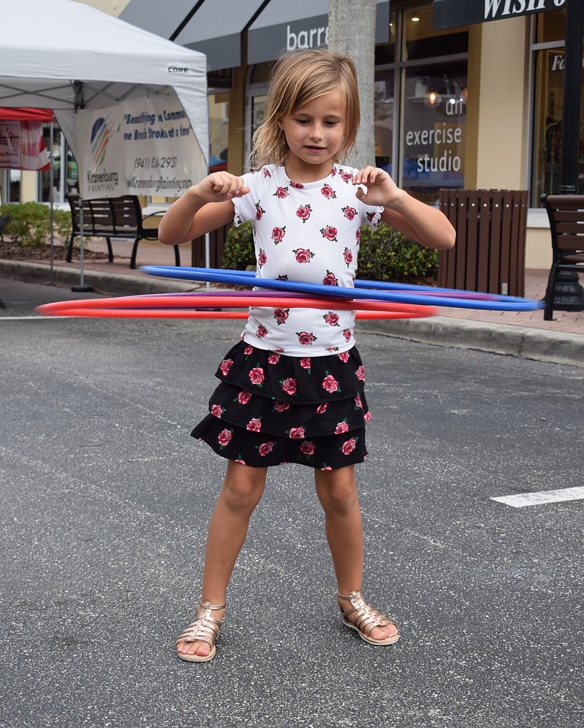 Lakewood Ranch's Madelyn Fouche, 7, plays with three hula hoops. She later added a fourth.