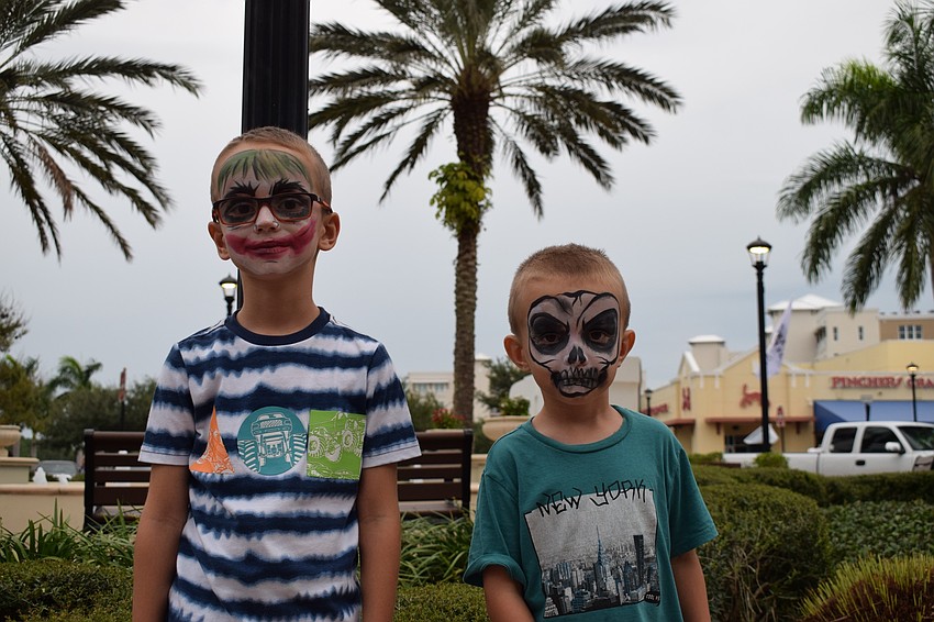 Four-year-old Patrick and 5-year-old Lucas Danielcak show off their face paint. Patrick chose the Joker because he's funny, and Lucas chose a skull because he likes skeletons.