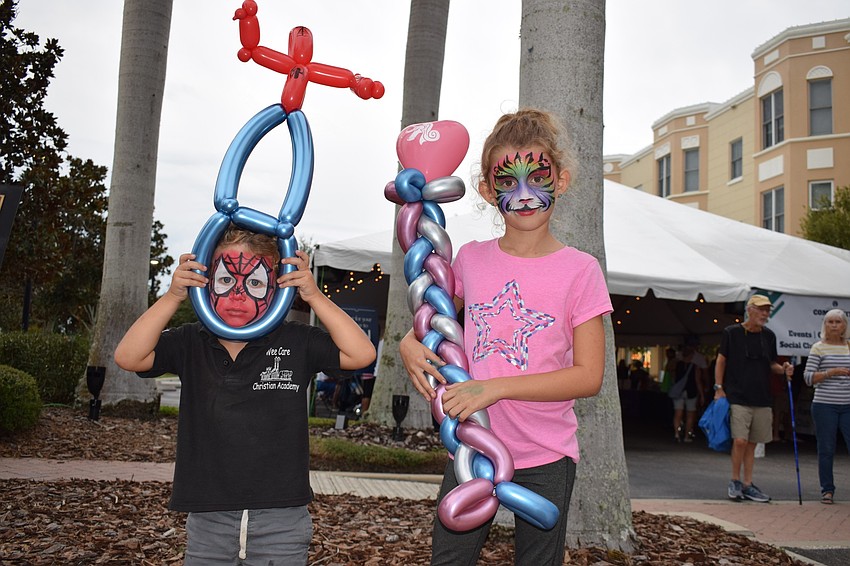 Trey and Heather Stewart love their new balloon creations and face paintings. Trey, 3, chose a Spider-Man balloon and face painting because it's his favorite superhero. Heather, 7, chose a rainbow tiger because it looked pretty.