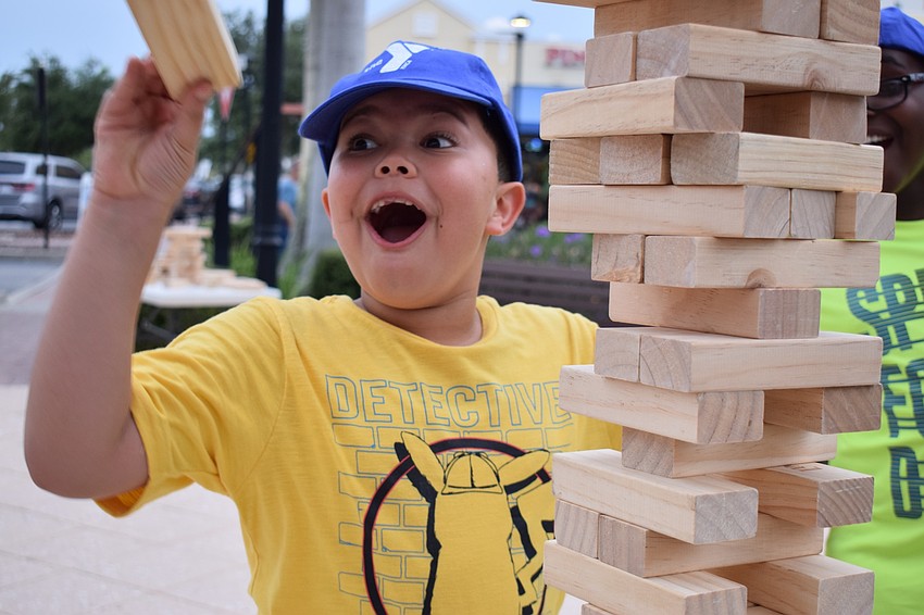 Bradenton's Alexander Greo, 6, surprises himself with his ability to extract a Jenga block from a tower.