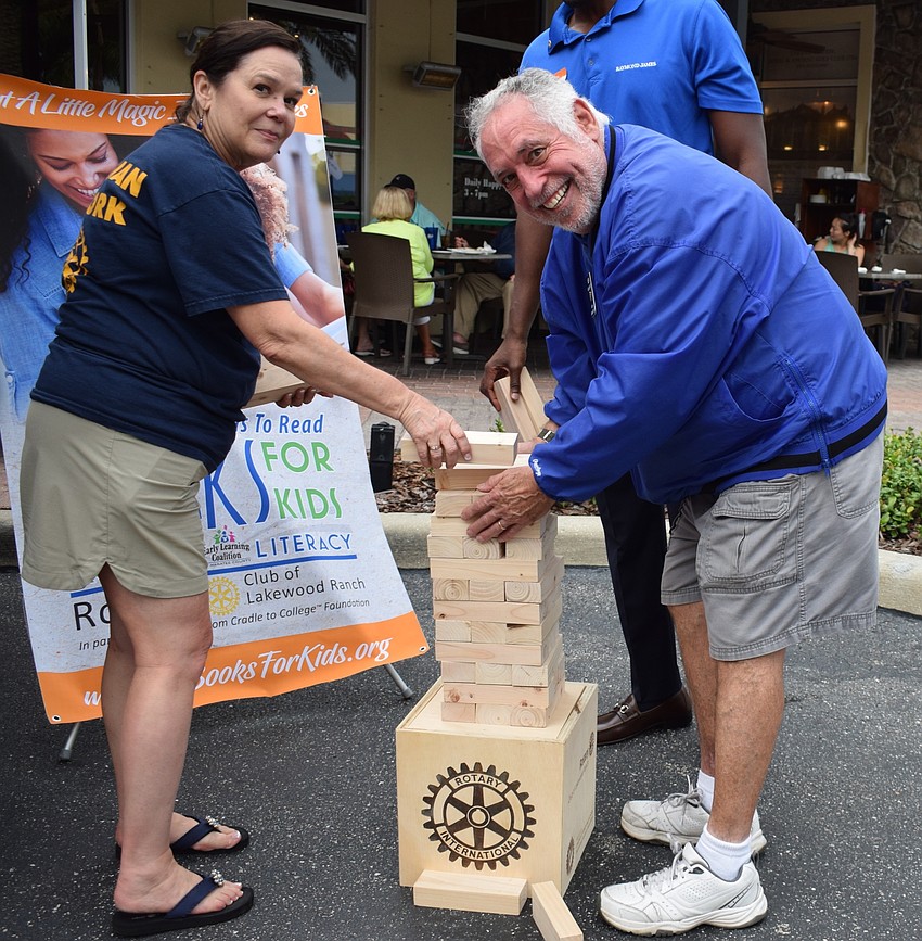Christi Womack Villalobos, current president of the Rotary Club of Lakewood Ranch, sets up a Jenga tower with Ken Kaplan, a past president of the club.