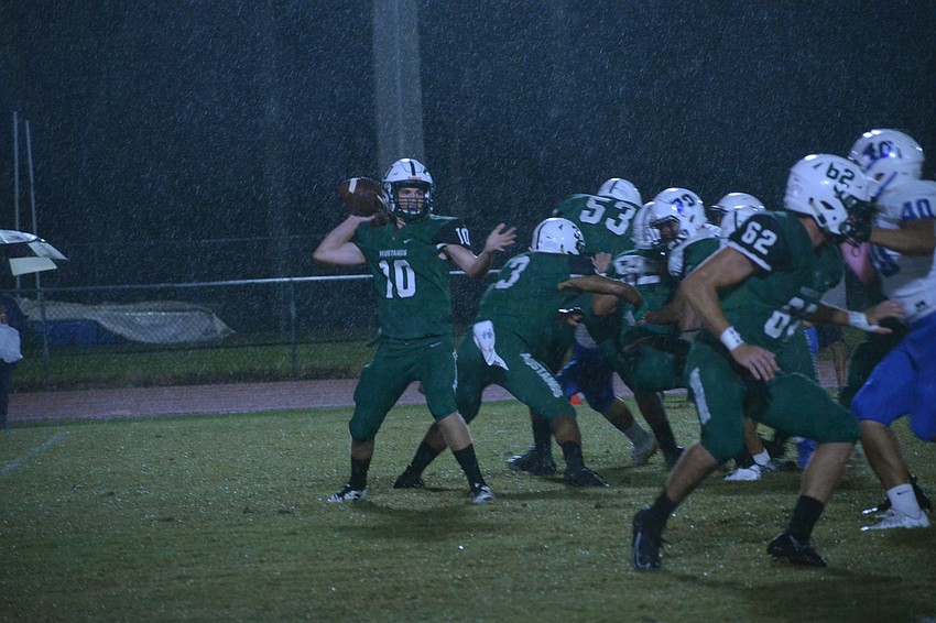 Lakewood Ranch quarterback Jimmy Kelly launches a pass in the rain.