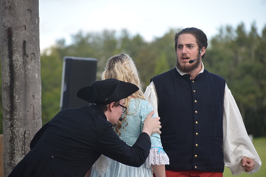 Wimpy Ichabod Crane (Philip Troyer) uses Katrina Van Tassel (Hannah Doster) to shield himself from Brom Bones (Tanner Fults).
