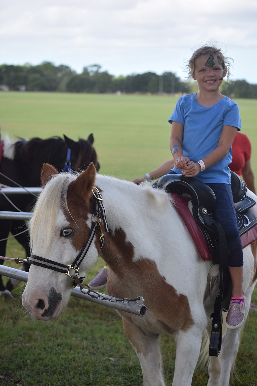 Lakewood Ranch 7-year-old Abby Berent enjoys a pony ride, provided by Jenny's Party Ponies of Riverview, before the show.