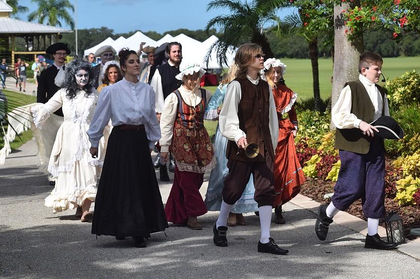 Members of the cast walk to the stage before the event at the Sarasota Polo Club.