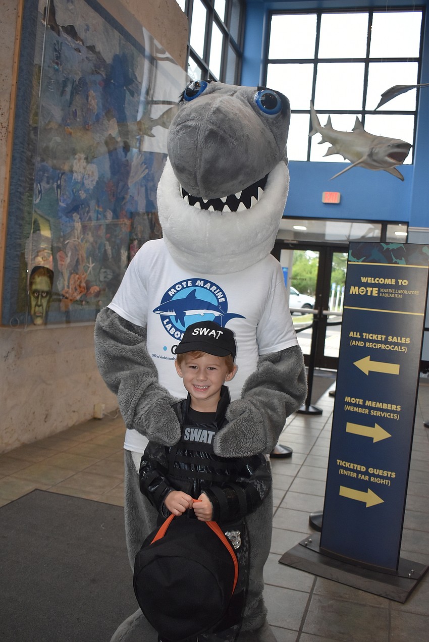Alex Peric poses with Gilly the shark.
