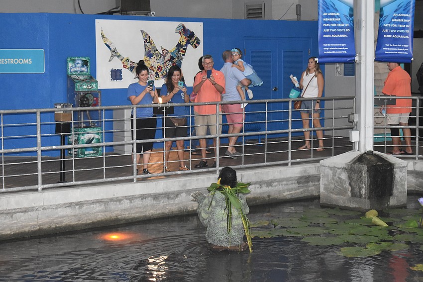 A swamp monster comes out of the water to spook some patrons.