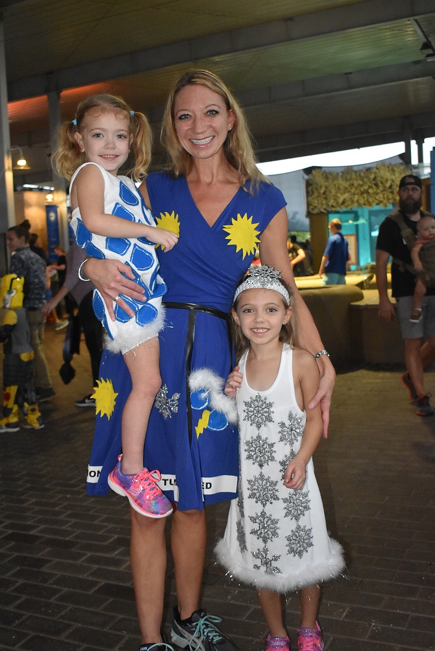 Heather, Kiersten and Sydney Stelmok dressed as a weather forecast.
