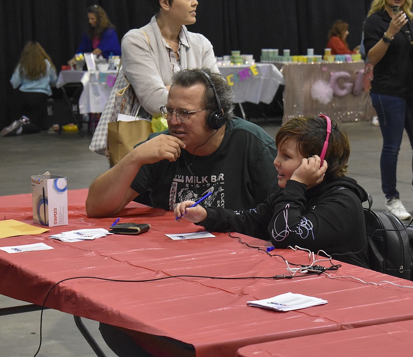 Brenden and Abigail Roye, 9, watch the ASMR film festival.