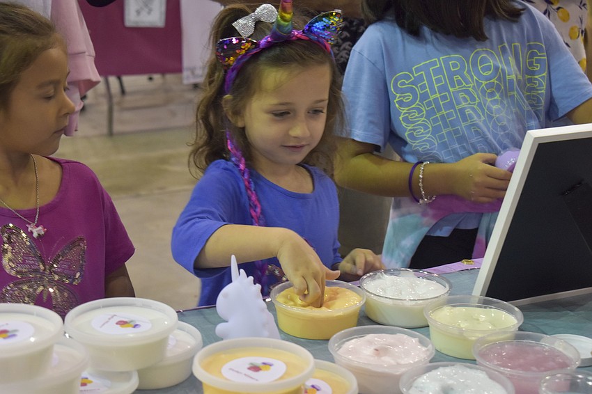 Avery Arnold, 4, tests out some slime.