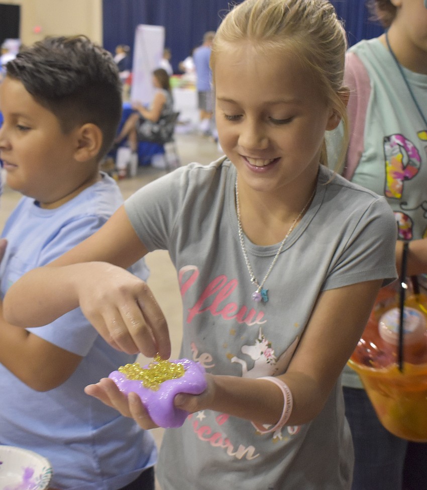 Kylie Reed, 11, makes her own slime during one of the slime classes.