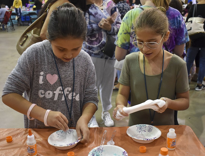 Olivia Schaedlerluera, 10, and Vanessa Oser, 10, mix together their slimes.
