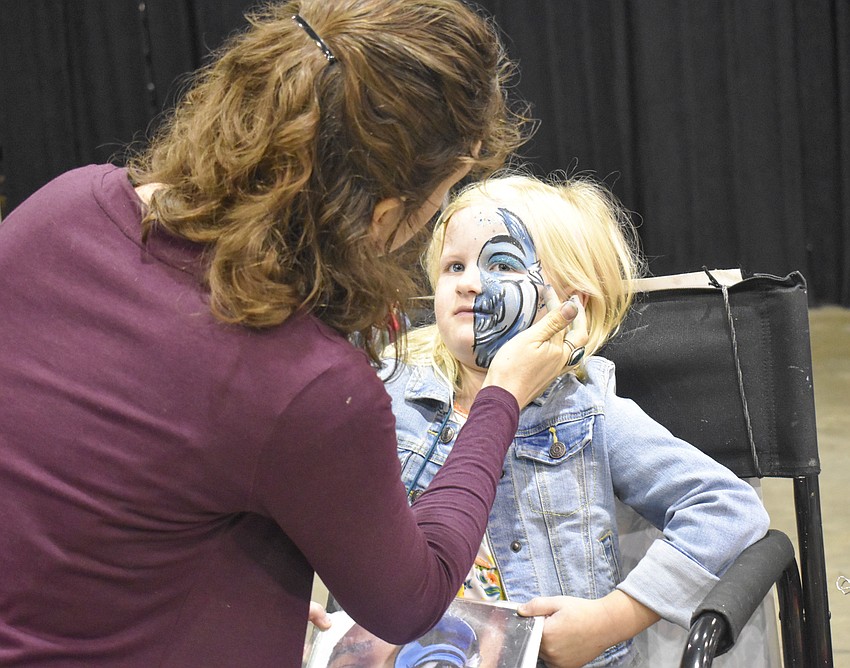 Callie Smith, 6, gets her face painted.
