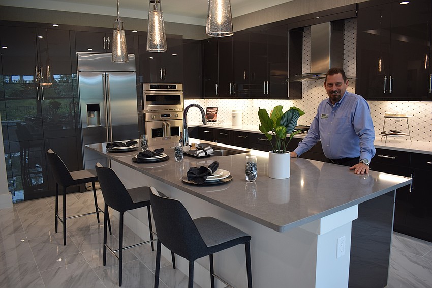 New Home Consultant Don Mihalik shows off the Vilano model's kitchen in Cresswind.