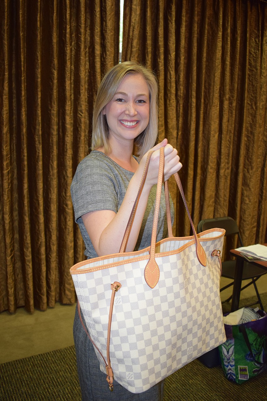 Amanda Tullidge of Blalock Walters bought her own Louis Vuitton purse to the event, just in case she didn't win one.