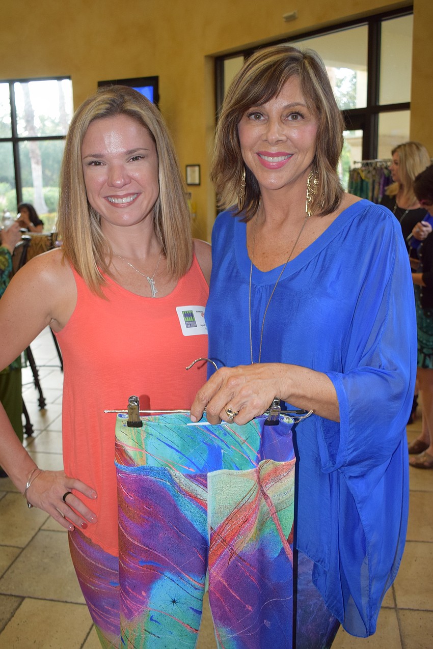 April Costello and Debbie Dannheisser look at the fashion line Dannheisser, a Sisterhood for Good member, designed for Costello's Limb-Laugh-Love of Florida nonprofit.