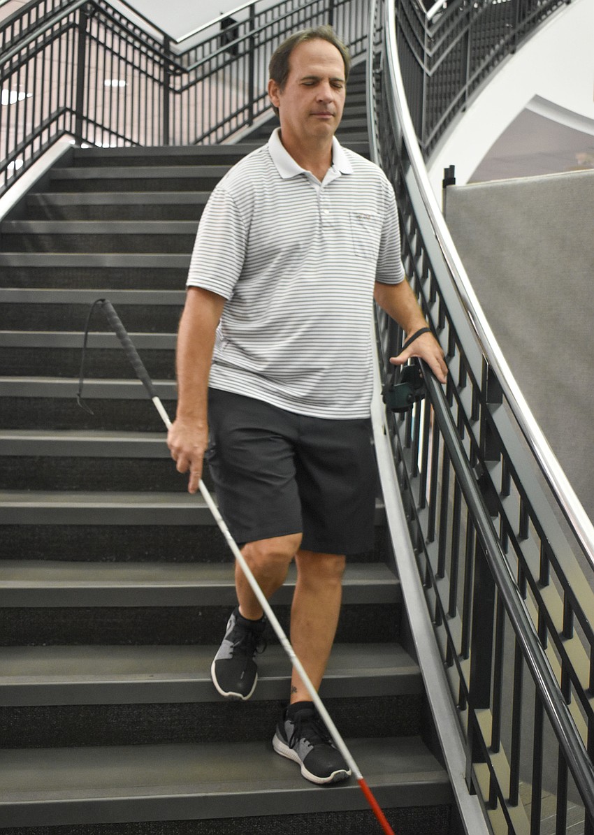 Martin Rometsch makes his way to the bottom of the stairs with his eyes closed.
