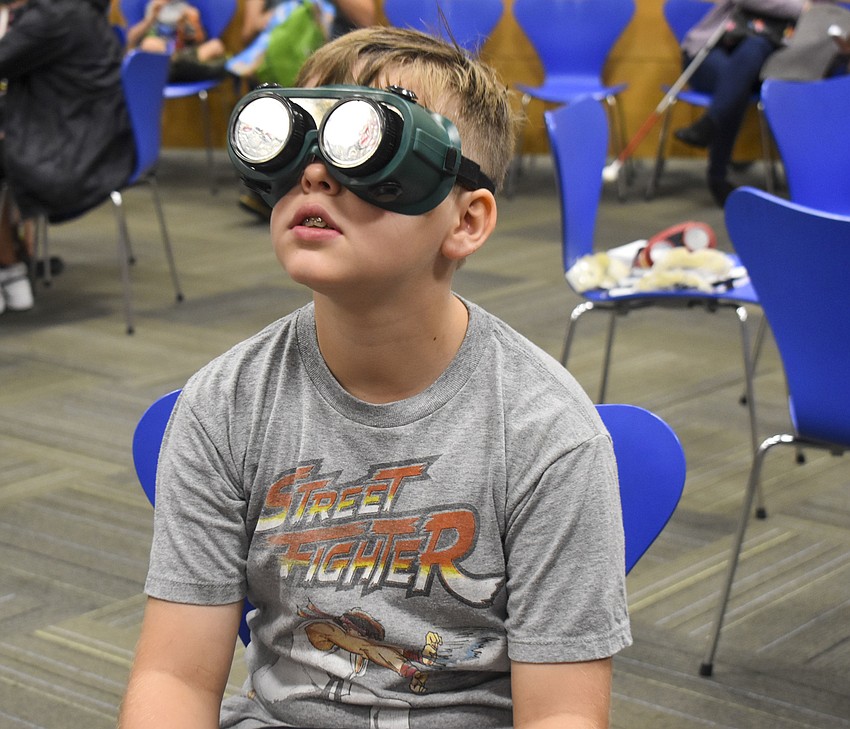 Clark Plank, 10, looks through his vision impairment goggles.