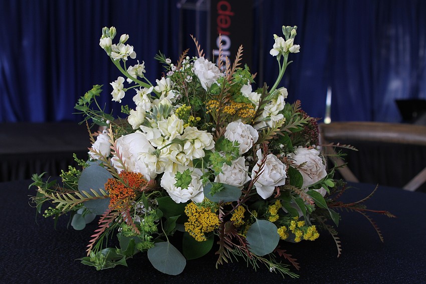 Each table had an arrangement of flowers.