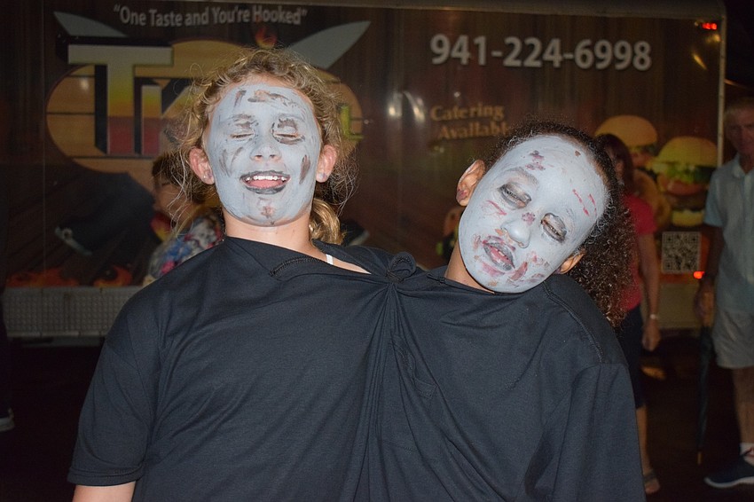 Bradenton 10-year-olds Rylie Herranz and Shaniah Stewart walk Boo Fest as a two-headed zombie.
