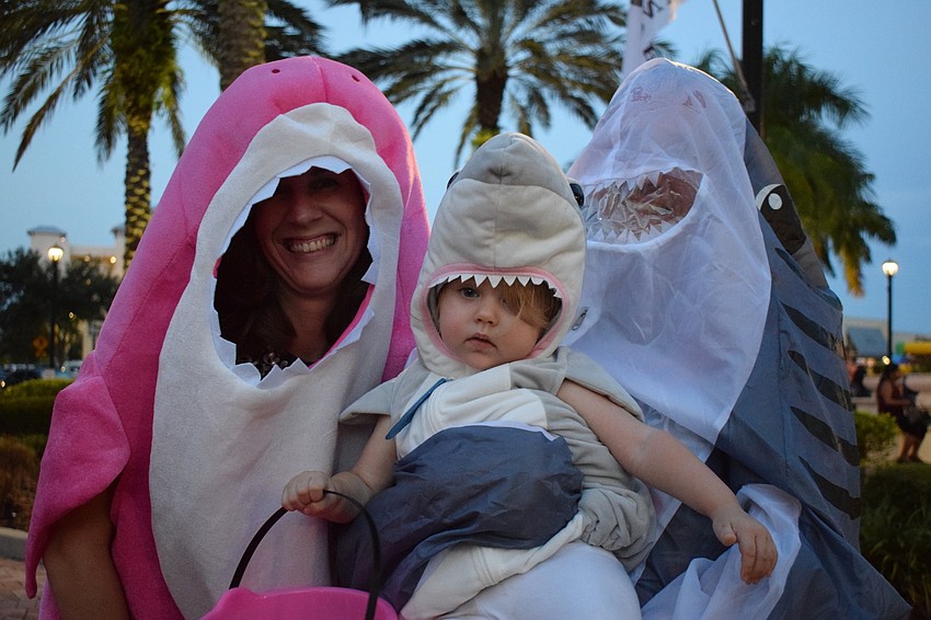 Lakewood Ranch residents Vaughna Wells, Kaija Thoyre, 16 months, and Sam Thoyre dress as sharks because Kaija's favorite song is 