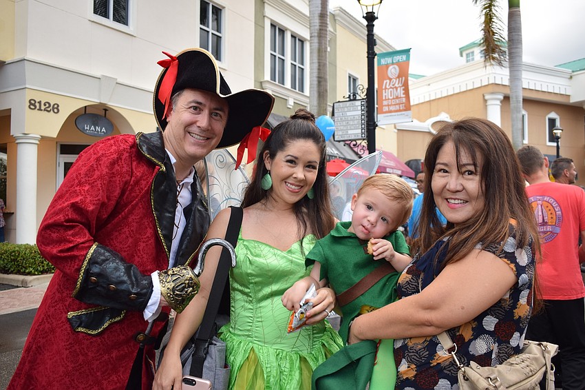 Sarasota residents Ryan, Jessica and Landon Featherstone, 20 months, and Yong Stewart dress as Captain Hook, Tinkerbell and Peter Pan.
