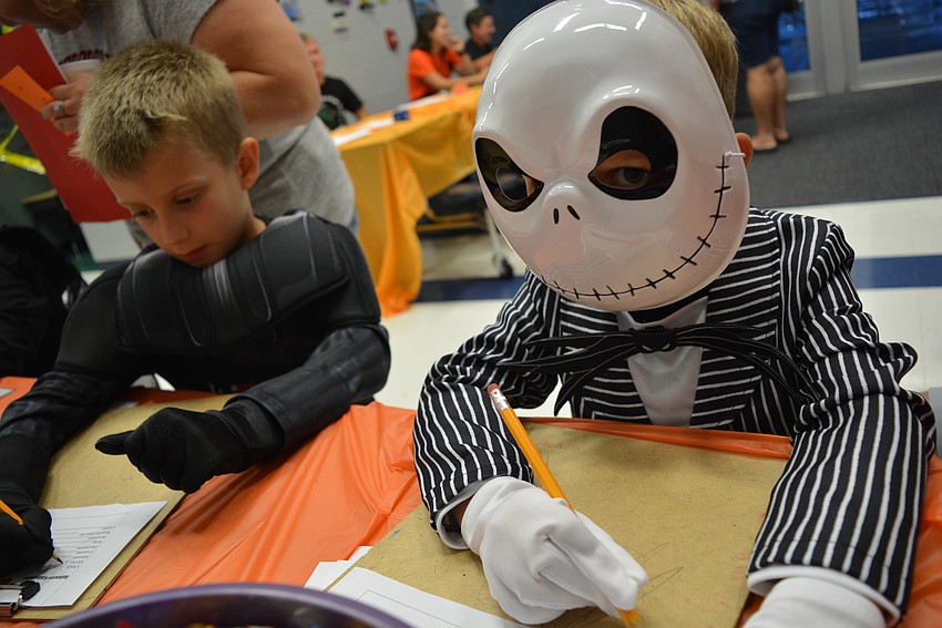 Cole and Logan Dressel do their best to complete a Halloween Scattergories-inspired word game.