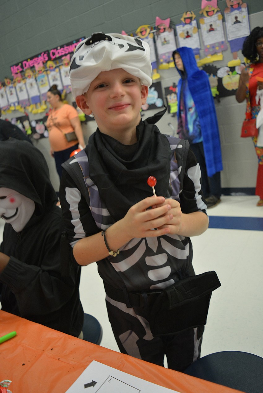 Second-grader Hunter Hayes orders the life cycle of a pumpkin during a learning activity.