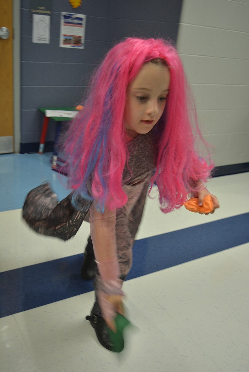 Second-grader Malin Ison shows great aim at the tombstone (bean bag) toss game.