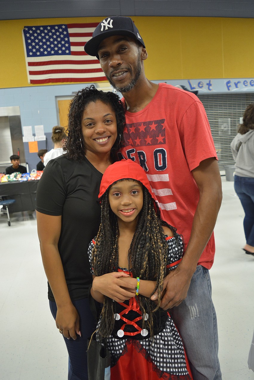 Third-grader Ali'Yana Jone, with her parents Marquita and Donald Jones, came as Little Miss Riding Hood. 
