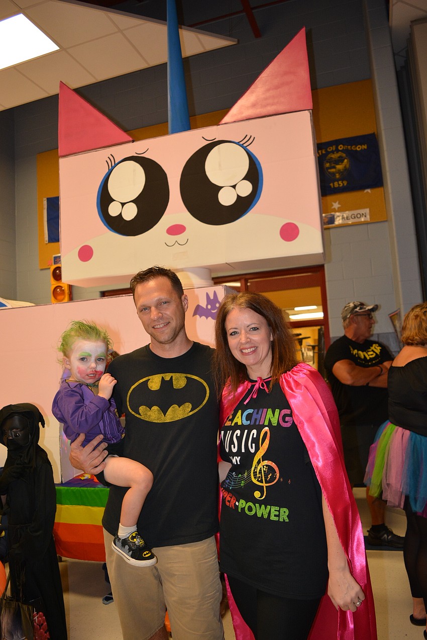 Billy and Elizabeth Kimbrell, pictured with their 2-year-old son Willy, came with a roughly 15-foot tall LEGO Movie Unikitty for their trunk-or-treat booth. Elizabeth Kimbrell is the school's music teacher.