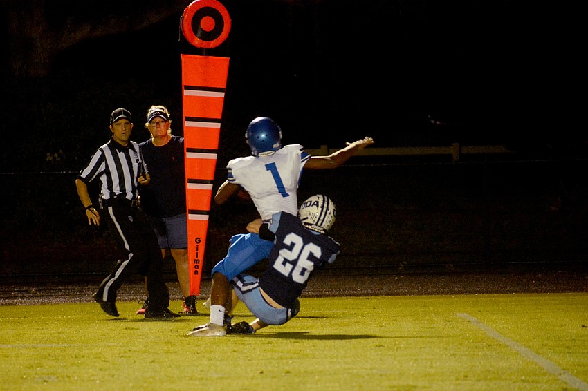 ODA junior cornerback Brayden Nelson corrals Gateway Charter's Ja'daniel Leaphart.