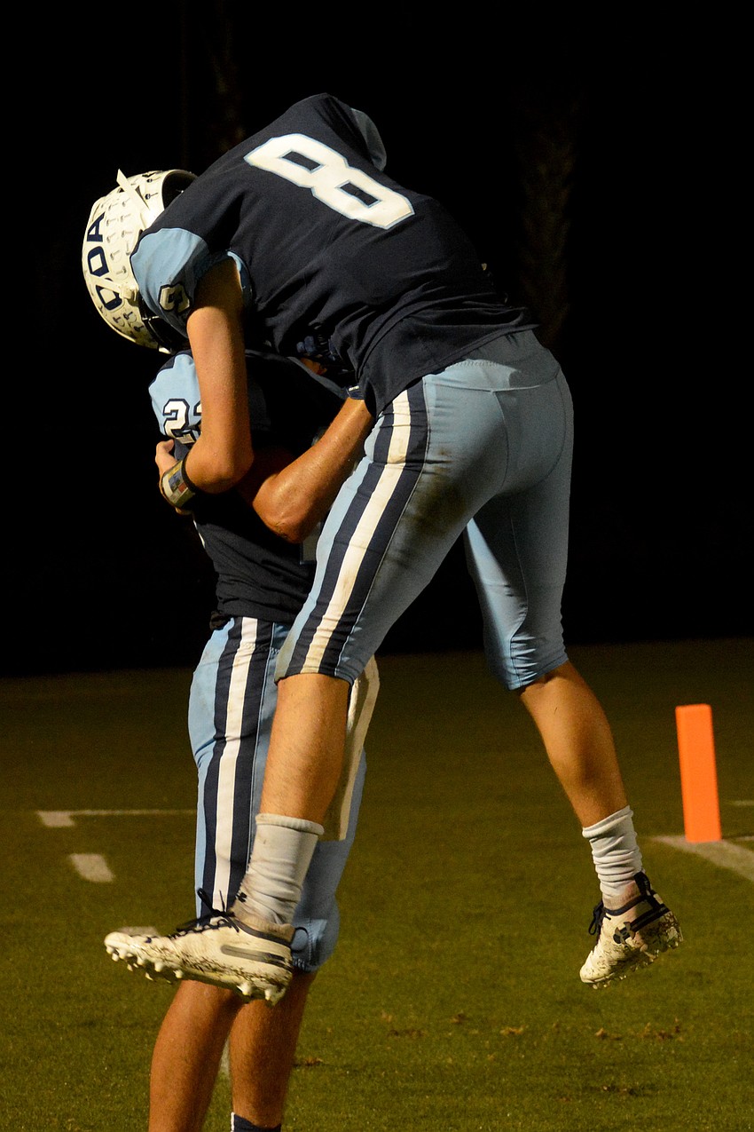 ODA junior Patrick O'Keefe leaps on junior Nolan Lewellen after Lewellen's end zone interception.