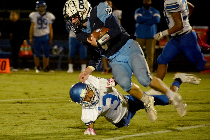ODA senior running back Jarred Flahive flies in the air after a collision.
