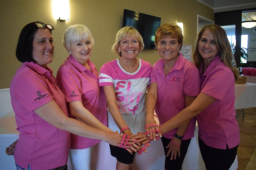 Volunteers Mary Tighe, Sheri Miller, Del Potter, Dee Lovell and Julie Veith celebrate after finishing their work at the Play for Pink golf tournament.