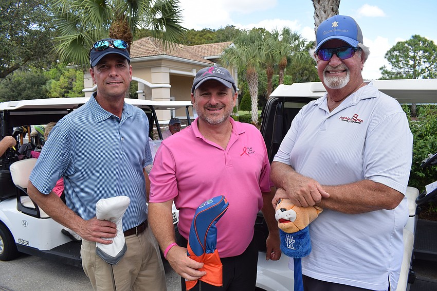 Rob Wenzel, Bryan Veith and John Barnott get ready for their first hole of the Play for Pink tournament.