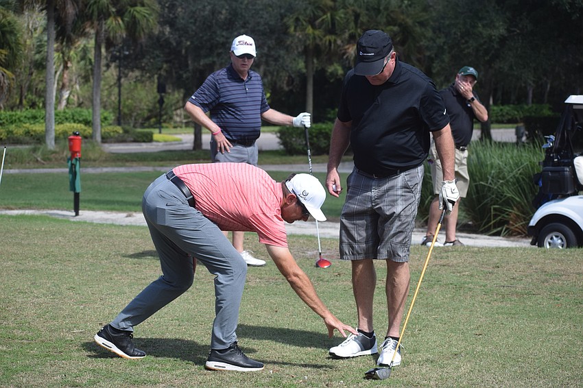 Jon Bullas, the director of golf instruction at Laurel Oak Country Club, gives Windermere's Kenny Blanton a few tips before he tees off.