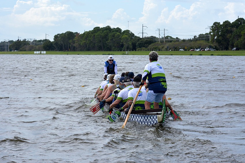 The NBP Dragons 200m premier/senior mixed 20 team warms up before the race.