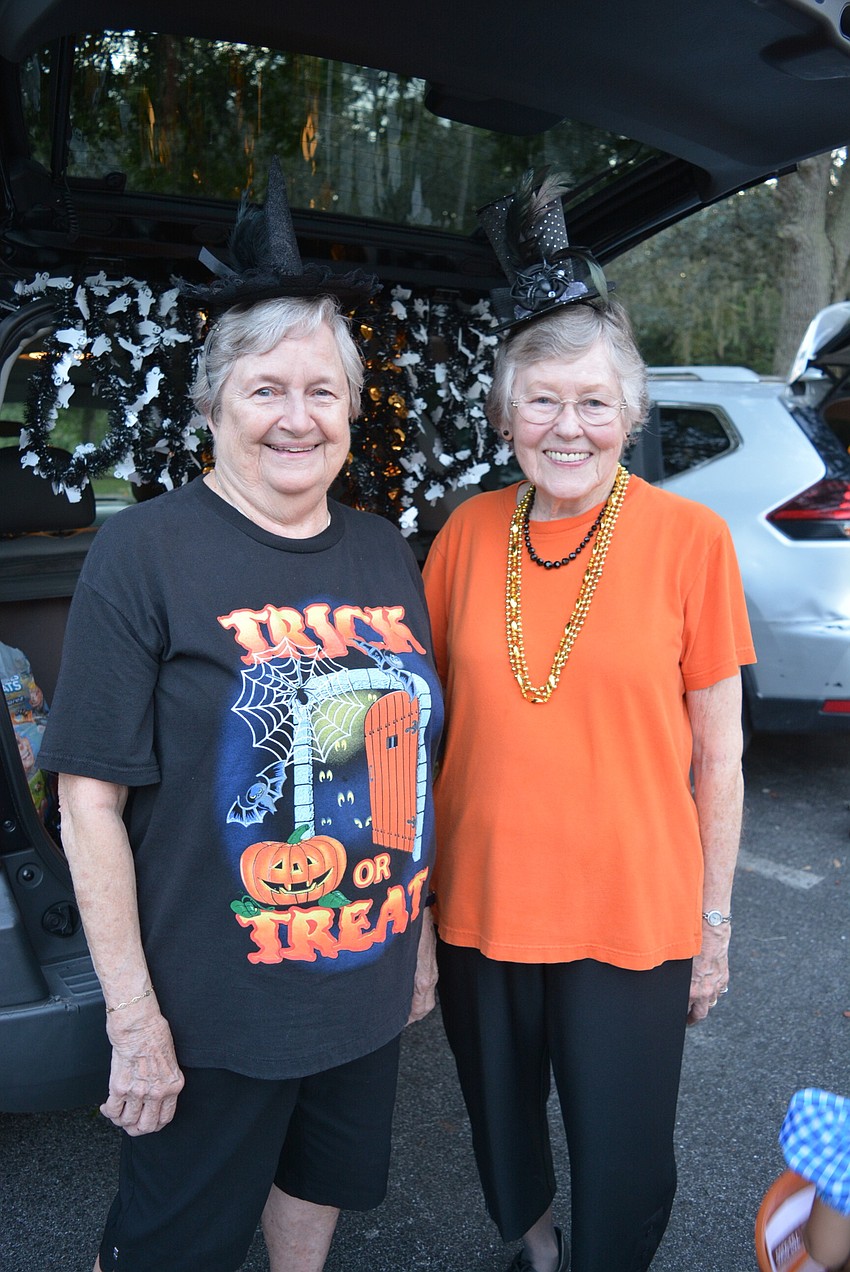 Carol Daly and Patty Kunkel had fun wearing Halloween inspired hats as they passed out treats.