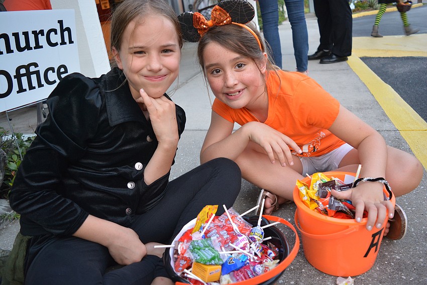 Nine-year-olds Alyssa Otterness and Anna Heuss had buckets filled to their brims.