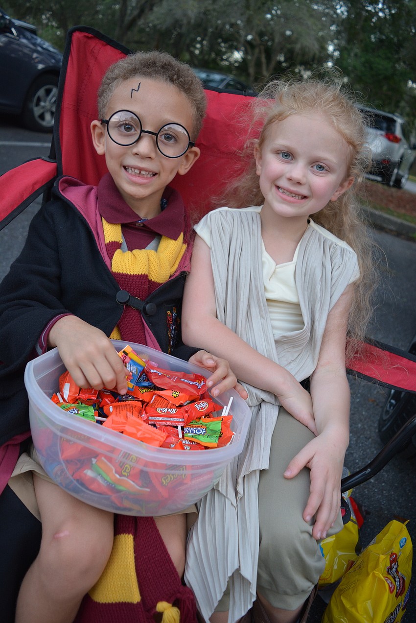 Six-year-old Jordan Williams and 7-year-old Anna Mylett helped pass out candy at Williams' 
