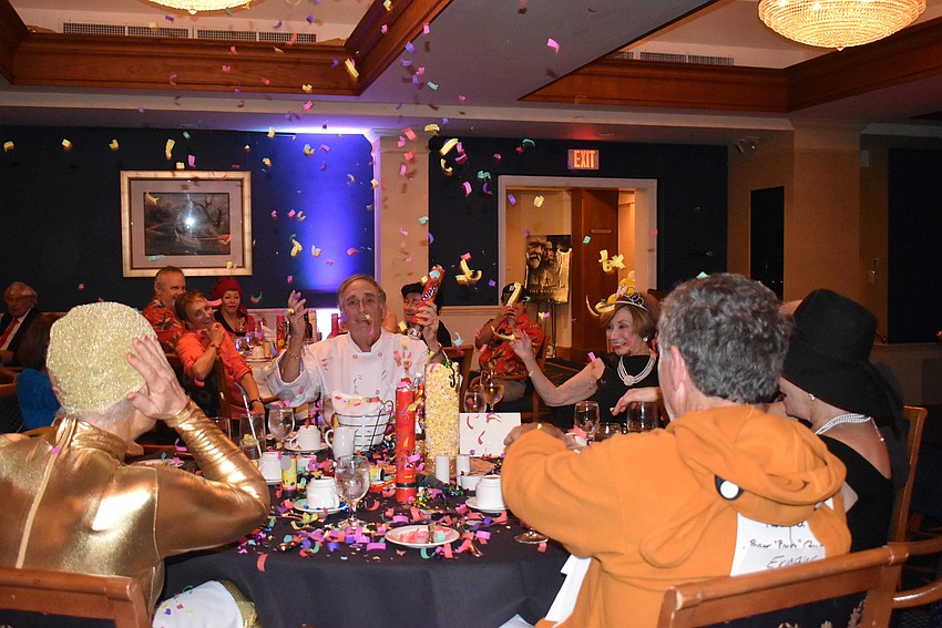 Confetti rains down on the table.