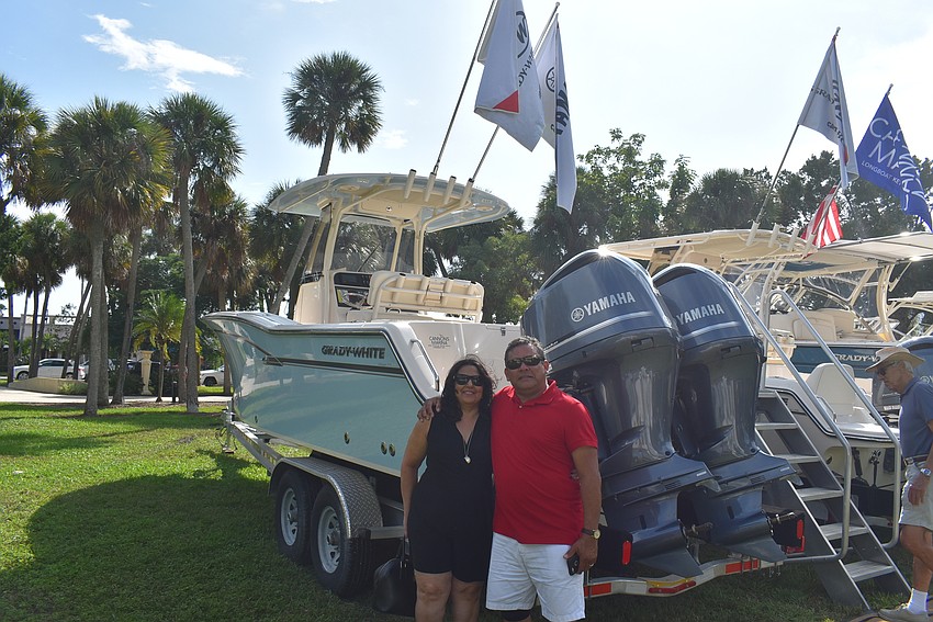 Ileana Bermudez and Azael Abrego in front of the line of boats.