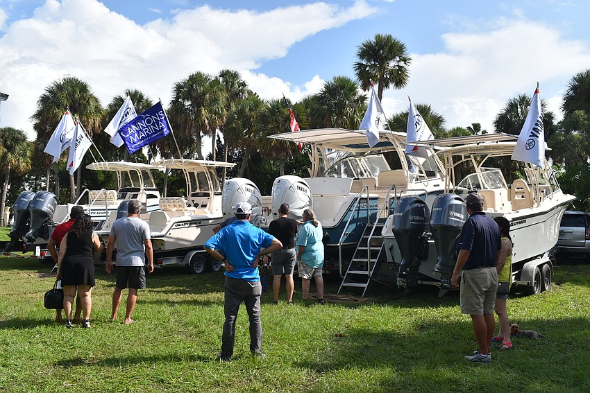 A group gathers to take in the landbound vessels.