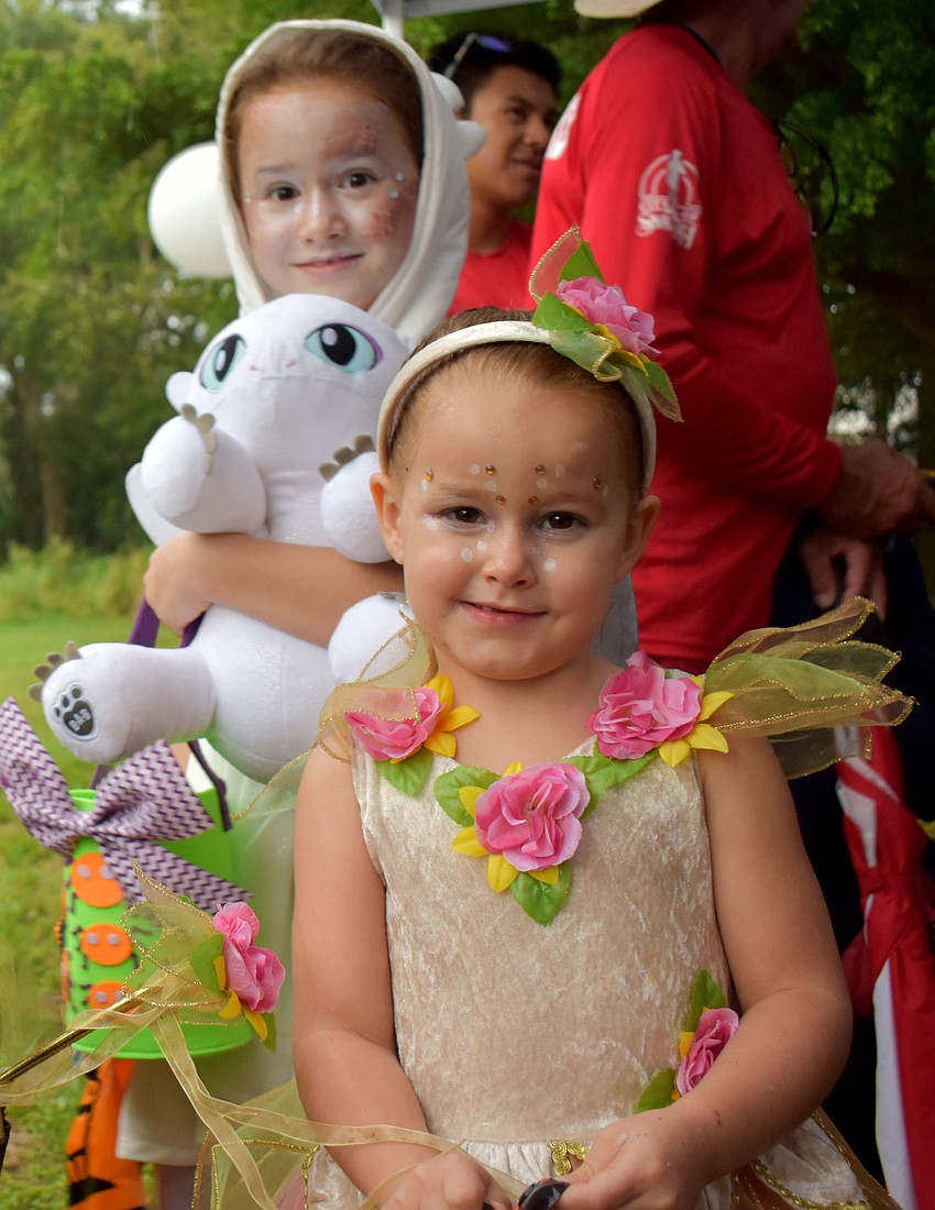 Luna, 7, and Israel, 4, hide under a tent from the rain.